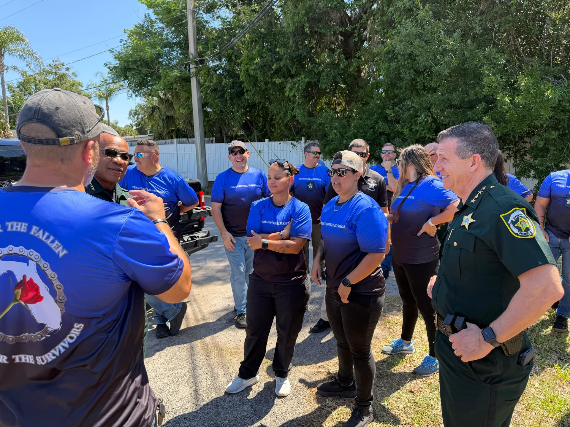 Team Central Florida riders talking with partner agency officers outdoors